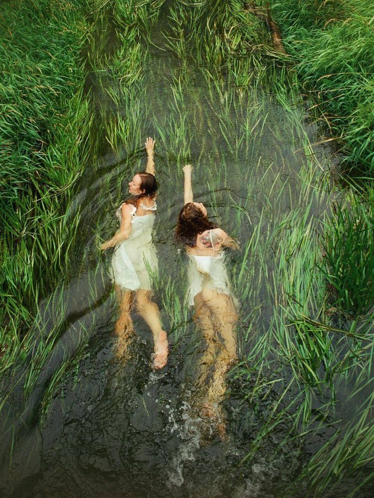 two girls swimming in lake